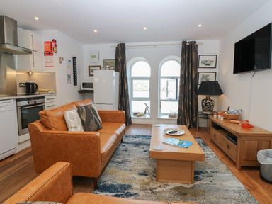 A living room with a sofa and coffee table at Mill Wharf in Berwick-upon-Tweed