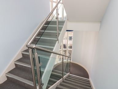 A staircase with a handrail and wall at Mill Wharf in Berwick-upon-Tweed