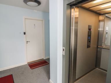 A hallway with an elevator and door at Mill Wharf in Berwick-upon-Tweed
