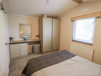 A bedroom with a bed and desk at Hadrian's Rest in Wigton