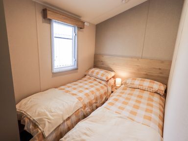 A bedroom with two beds and a window at Hadrian's Rest in Wigton