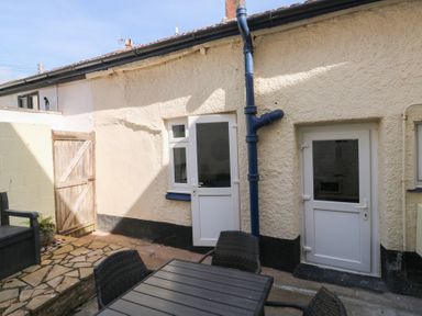 An outdoor area with doors and a stone floor at The Cottage Budleigh Salterton