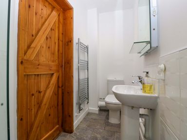 A bathroom with a wash basin and towel radiator at Castle Rag in Lydney