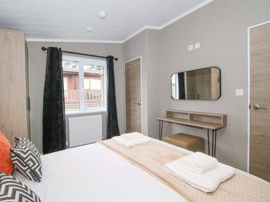 A bedroom with a bed and a desk at Tulip in Eardisland