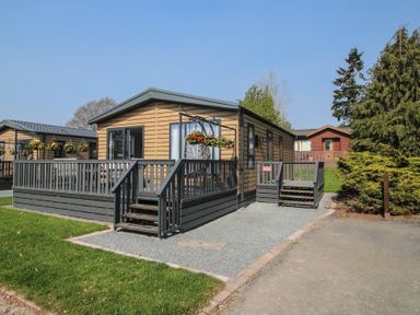 A house with a deck and planters at Tulip in Eardisland