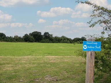 A nature trail sign in a grassy field at Poppy in Eardisland