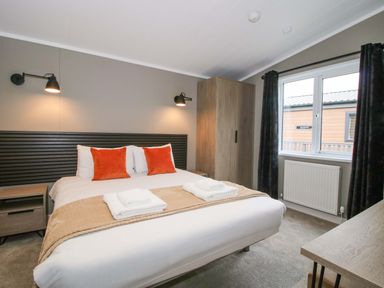 A bedroom with a bed and window at Poppy in Eardisland