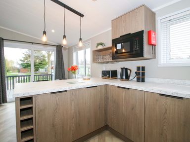 A kitchen with appliances and a window at Poppy in Eardisland