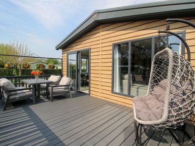 An outdoor patio with a table and chairs at Poppy Eardisland