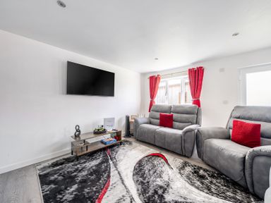 A living room with a sofa and TV at Ruby Red near Brigg
