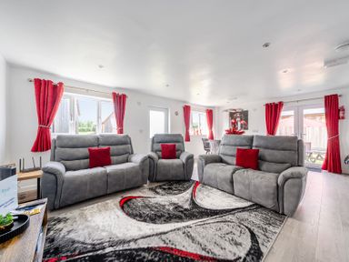 A living room with sofas and large windows at Ruby Red near Brigg