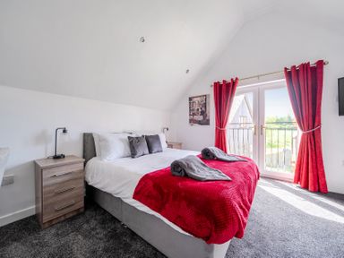 A bedroom with a bed and furniture at Ruby Red Near Brigg