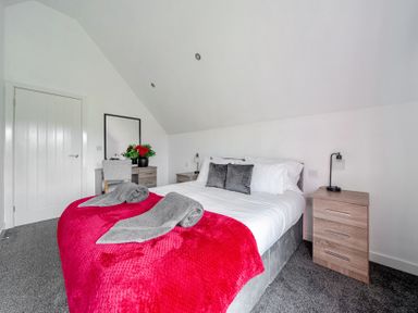 A bedroom with a bed and bedside table at Ruby Red near Brigg