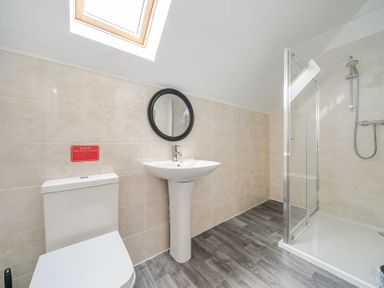 A bathroom with a toilet, wash basin, and shower at Ruby Red near Brigg