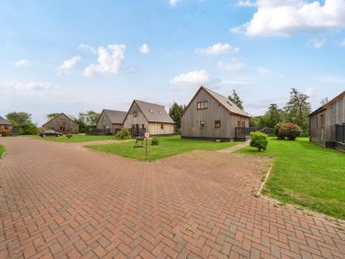 An overview of multiple houses with a path and grass area at Pumpkin Lodge near Brigg