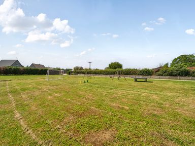 An outdoor area with a goal post, swing set, and traffic cones at Pumpkin Lodge near Brigg