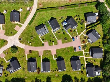 An aerial view of a residential area with houses and gardens at Pumpkin Lodge near Brigg