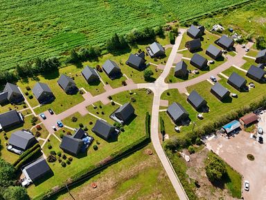 An aerial view of a residential area with houses and roads at Pumpkin Lodge near Brigg