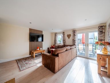 A living room with a sofa and television at Lodge 25 - Pumpkin Near Brigg