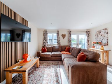 A living room with a sofa and television at Lodge 25 - Pumpkin near Brigg