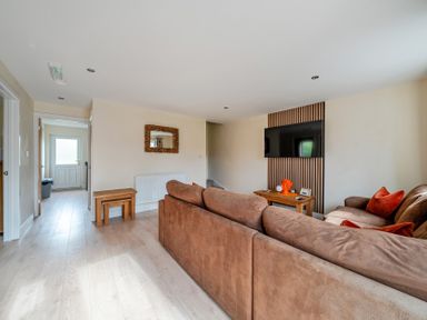 A living room with a sofa and table at Lodge 25 - Pumpkin near Brigg