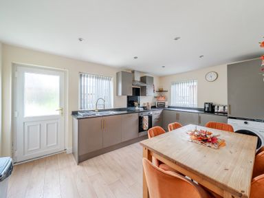 A kitchen with a sink and table at Lodge 25 - Pumpkin Near Brigg