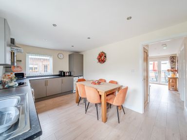 A kitchen with table and chairs at Lodge 25 - Pumpkin near Brigg