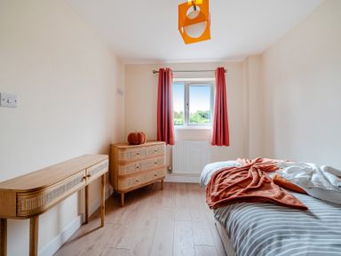 A bedroom with a bed and dresser at Lodge 25 - Pumpkin near Brigg