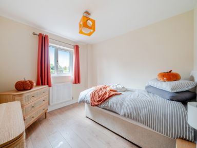 A bedroom with a bed and dresser at Lodge 25 - Pumpkin Near Brigg