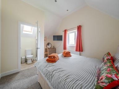 A bedroom with a bed and towels on top at Lodge 25 - Pumpkin Near Brigg