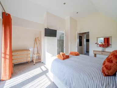 A bedroom with a bed and a dresser at Lodge 25 - Pumpkin near Brigg