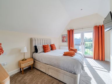 A bedroom with a bed and curtains at Lodge 25 - Pumpkin near Brigg