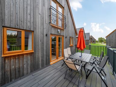 An outdoor seating area with table and chairs at Lodge 25 - Pumpkin Near Brigg