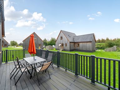 An outdoor seating area with a table and chairs at Lodge 25 - Pumpkin near Brigg