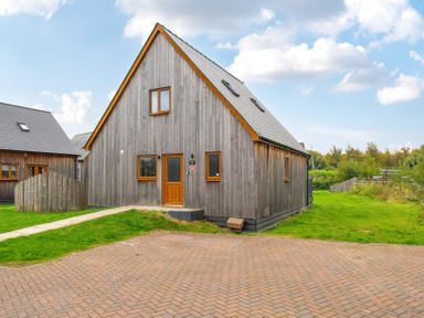 A wooden house with windows and door at Lodge 25 - Pumpkin near Brigg