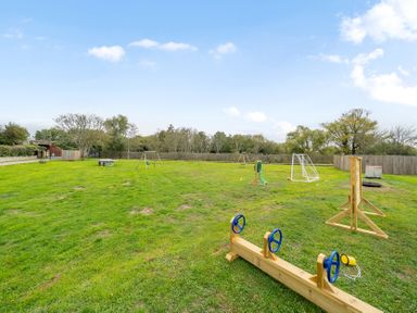 An outdoor area with playground equipment and a picnic table at Lodge 25 - Pumpkin near Brigg