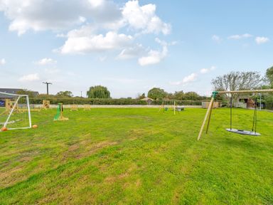 An outdoor area with goalposts and swings at Lodge 25 - Pumpkin Near Brigg