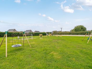 An outdoor play area with swings and target boards at Lodge 25 - Pumpkin near Brigg