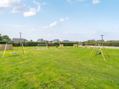 An outdoor play area with swings and goal post at Lodge 25 - Pumpkin near Brigg