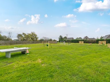 An outdoor area with a swing set, soccer goal, and picnic table at Lodge 25 - Pumpkin near Brigg