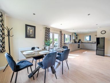 A dining area with a table and chairs at Poker Lodge Near Brigg