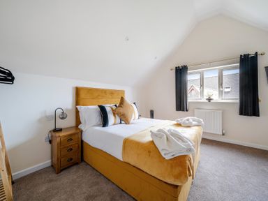 A bedroom with a bed and window at Poker Lodge near Brigg
