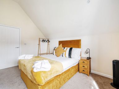 A bedroom with a bed and bedside table at Poker Lodge Near Brigg