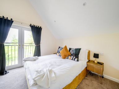 A bedroom with a bed and nightstand at Poker Lodge Near Brigg