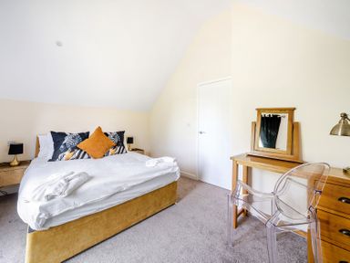 A bedroom with a bed and a mirror at Poker Lodge Near Brigg