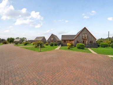 Houses with a walkway and grass at Poker Lodge Near Brigg