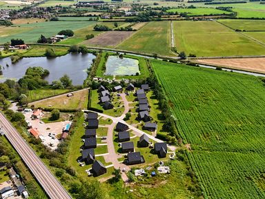 An aerial view of houses and a pond at Poker Lodge near Brigg