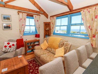 A living room with a sofa and window at Casa Mia in Goodwick