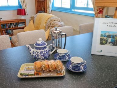 A dining room with tea set and scones at Casa Mia in Goodwick