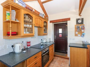 A kitchen with cabinets and a stove at Casa Mia in Goodwick